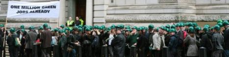 crowd wearing green hard hats outside the Treasury